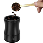 Coffee beans poured from a measuring scoop into the black dosing cup on the digital scale