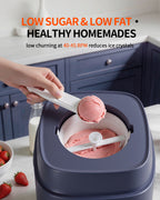 Scoop lifting strawberry ice cream from the removable mixing bowl with paddle visible